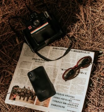 black point and shoot camera on white printer paper